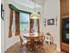 Bright breakfast nook with charming window, floral curtains, and decorative chandelier lighting at 5235 Island Terrace Ct, Lady Lake, FL 32159
