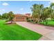 Charming home featuring a brick driveway, two-car garage, manicured lawn and mature landscaping at 5235 Island Terrace Ct, Lady Lake, FL 32159