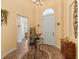 Inviting foyer with decorative table, high ceilings, chandelier, and tiled floors at 5235 Island Terrace Ct, Lady Lake, FL 32159
