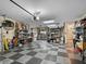 Spacious garage with a checkered floor and ample storage shelving at 5235 Island Terrace Ct, Lady Lake, FL 32159