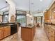 Kitchen with an island, granite countertops, stainless steel appliances, and a view of the pool at 5235 Island Terrace Ct, Lady Lake, FL 32159
