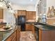 Kitchen with granite countertops, wood cabinetry, stainless appliances, tile floors, and an open design at 5235 Island Terrace Ct, Lady Lake, FL 32159