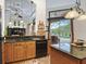 Open kitchen featuring an island, granite countertops, stainless steel appliances, and a view of the pool at 5235 Island Terrace Ct, Lady Lake, FL 32159