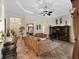 Spacious living room with a ceiling fan, decorative rug, elegant furnishings and decorative ceiling design at 5235 Island Terrace Ct, Lady Lake, FL 32159