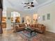 Bright living room featuring tile floors, neutral walls, high ceilings, and views into the kitchen at 5235 Island Terrace Ct, Lady Lake, FL 32159