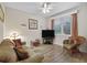 Inviting living room with comfortable seating, a ceiling fan, and natural light from the window at 5235 Island Terrace Ct, Lady Lake, FL 32159