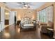Spacious main bedroom with hardwood floors, ceiling fan, and access to the bathroom and closet at 5235 Island Terrace Ct, Lady Lake, FL 32159