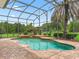 Inviting pool inside screened enclosure at 5235 Island Terrace Ct, Lady Lake, FL 32159