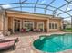 Lounge by the refreshing pool, surrounded by a screened enclosure for year-round enjoyment at 5235 Island Terrace Ct, Lady Lake, FL 32159