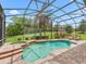 Relax in the tranquil pool with its screened enclosure and beautiful surrounding landscape at 5235 Island Terrace Ct, Lady Lake, FL 32159