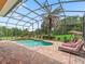 Sparkling pool featuring a sun shelf, waterfall feature, and comfortable lounge chairs at 5235 Island Terrace Ct, Lady Lake, FL 32159