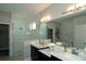 Contemporary bathroom featuring dual sinks, a glass-enclosed shower, and a separate soaking tub at 5390 Marshelder St, Apopka, FL 32712