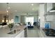 Bright, open-concept kitchen with a large island, stainless steel appliances, and a view of the living area at 5390 Marshelder St, Apopka, FL 32712