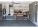 Garage with a workbench, storage solutions, water heater, and access to the exterior at 5436 Astor St, Leesburg, FL 34748