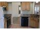 Galley kitchen featuring stainless steel appliances, granite countertops, ample cabinetry, and an open view into the living area at 5436 Astor St, Leesburg, FL 34748