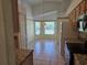 Spacious kitchen featuring tiled floor, warm lighting, granite countertops, and views into the breakfast nook at 5436 Astor St, Leesburg, FL 34748