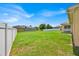 Green backyard with a tall fence and distant house views at 5556 Vintage View Blvd, Lakeland, FL 33812