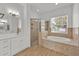 Modern bathroom with tub, shower, double sinks and luxury finishes at 5556 Vintage View Blvd, Lakeland, FL 33812