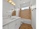 Modern bathroom with dual sinks, quartz countertop, and a shower-tub combination at 5556 Vintage View Blvd, Lakeland, FL 33812