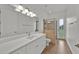 A modern bathroom featuring a quartz countertop, a large mirror, and a tiled shower at 5556 Vintage View Blvd, Lakeland, FL 33812