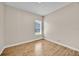 A bright, empty bedroom with wood floors and a large window at 5556 Vintage View Blvd, Lakeland, FL 33812