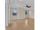 A spacious bedroom featuring wood floors, a ceiling fan, and natural light from two windows at 5556 Vintage View Blvd, Lakeland, FL 33812