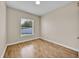 An empty bedroom with wood floors and a large window offering lots of light at 5556 Vintage View Blvd, Lakeland, FL 33812