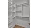 Walk-in closet with custom shelving and hardwood floors at 5556 Vintage View Blvd, Lakeland, FL 33812