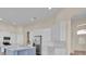 Bright, modern kitchen with white cabinetry, stainless steel appliances, and a stylish blue island at 5556 Vintage View Blvd, Lakeland, FL 33812
