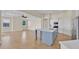 Bright, modern kitchen with white cabinetry, stainless steel appliances, and a stylish blue island at 5556 Vintage View Blvd, Lakeland, FL 33812