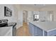 Bright, modern kitchen with white cabinetry, stainless steel appliances, and a stylish blue island at 5556 Vintage View Blvd, Lakeland, FL 33812