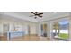 Open floor plan with kitchen, living area, and sliding glass doors leading to a patio at 5556 Vintage View Blvd, Lakeland, FL 33812