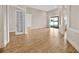 Bright living room with wood floors, white trim, and sliding glass doors to the outside at 5556 Vintage View Blvd, Lakeland, FL 33812