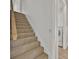 Carpeted staircase leads up to a second level, next to the laundry room at 5556 Vintage View Blvd, Lakeland, FL 33812
