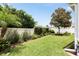 Well-maintained backyard with lush green lawn, manicured landscaping, and privacy fence, perfect for outdoor activities and relaxation at 579 Audrey Ln, The Villages, FL 32162