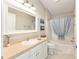 Bathroom featuring neutral colors, vanity, framed mirror, and shower/tub at 579 Audrey Ln, The Villages, FL 32162