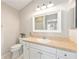 Bathroom featuring a toilet, vanity, framed mirror, and neutral colors at 579 Audrey Ln, The Villages, FL 32162