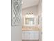 This bathroom has a framed mirror and vanity with storage at 579 Audrey Ln, The Villages, FL 32162