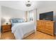 Bedroom includes wood floors, shutters, and neutral walls at 579 Audrey Ln, The Villages, FL 32162