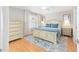 Bright bedroom features an area rug, a ceiling fan, and neutral paint at 579 Audrey Ln, The Villages, FL 32162