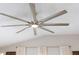 Modern ceiling fan complements the light-filled living space with neutral tones and stylish design at 579 Audrey Ln, The Villages, FL 32162