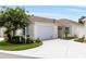 Charming home featuring a well-manicured lawn, attached garage, and inviting curb appeal at 579 Audrey Ln, The Villages, FL 32162