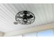 Close-up of modern ceiling fan with black metal cage design and overhead lighting in a room with white ceiling at 579 Audrey Ln, The Villages, FL 32162