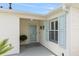 Welcoming front porch with light blue shutters and a decorative door, offering a cozy entrance at 579 Audrey Ln, The Villages, FL 32162