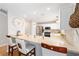Bright kitchen features white cabinets, stainless steel appliances, and a bar with seating at 579 Audrey Ln, The Villages, FL 32162