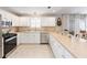 Bright kitchen featuring stainless steel appliances, gas range, and ample countertop space at 579 Audrey Ln, The Villages, FL 32162
