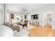 Spacious living room features hardwood floors, a comfortable sectional sofa, and a large entertainment center at 579 Audrey Ln, The Villages, FL 32162
