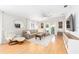 Relaxing living area with a large sectional sofa, cozy rug, and lots of natural light at 579 Audrey Ln, The Villages, FL 32162