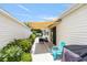 Back patio with retractable awning and outdoor seating, perfect for enjoying the weather and outdoor dining experiences at 579 Audrey Ln, The Villages, FL 32162
