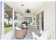 Relaxing sunroom featuring comfortable seating, stylish decor, and expansive windows overlooking the beautifully maintained backyard at 579 Audrey Ln, The Villages, FL 32162